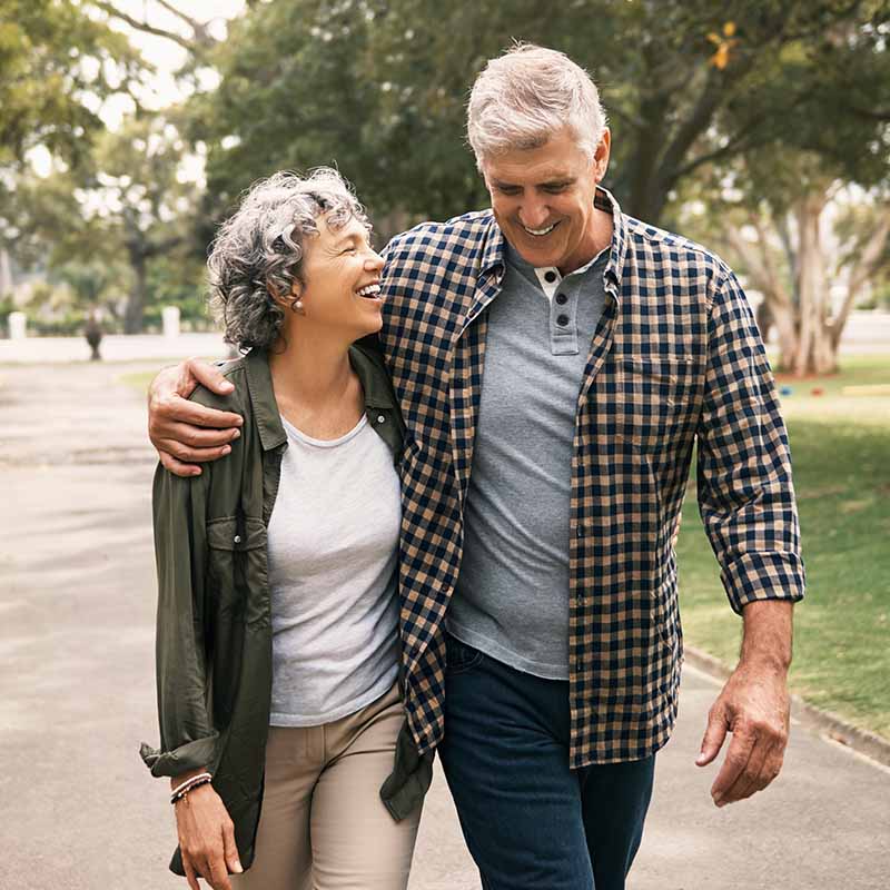 Happy couple walking outside after TRT from Serotonin Centers.