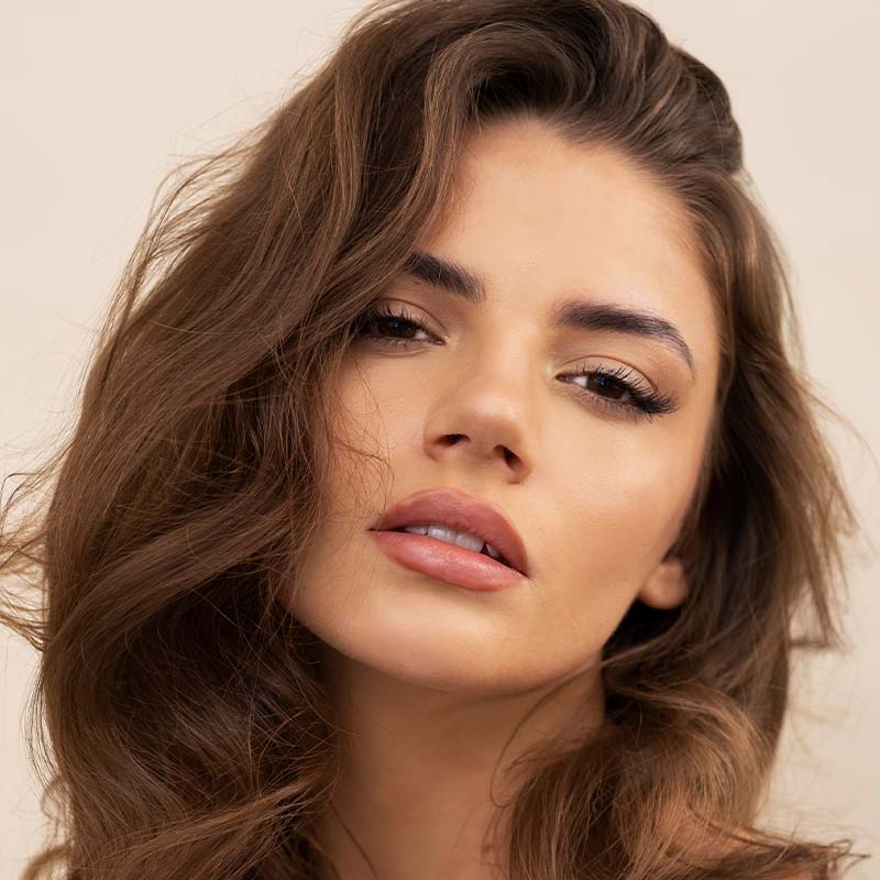 Beautiful woman after receiving microneedling from Serotonin Centers.